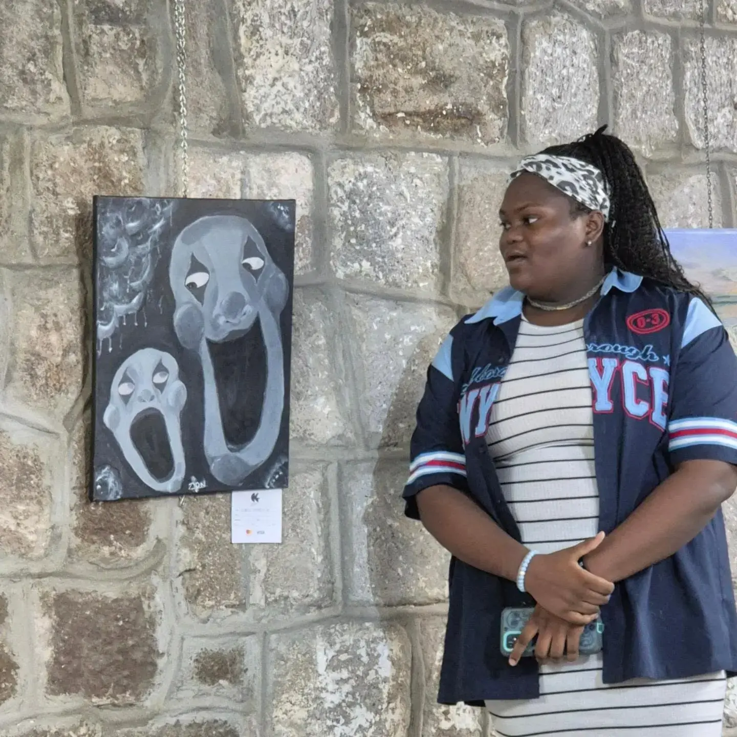 A mentee artist speaking about her work at the Bloom Where You're Planted exhibition